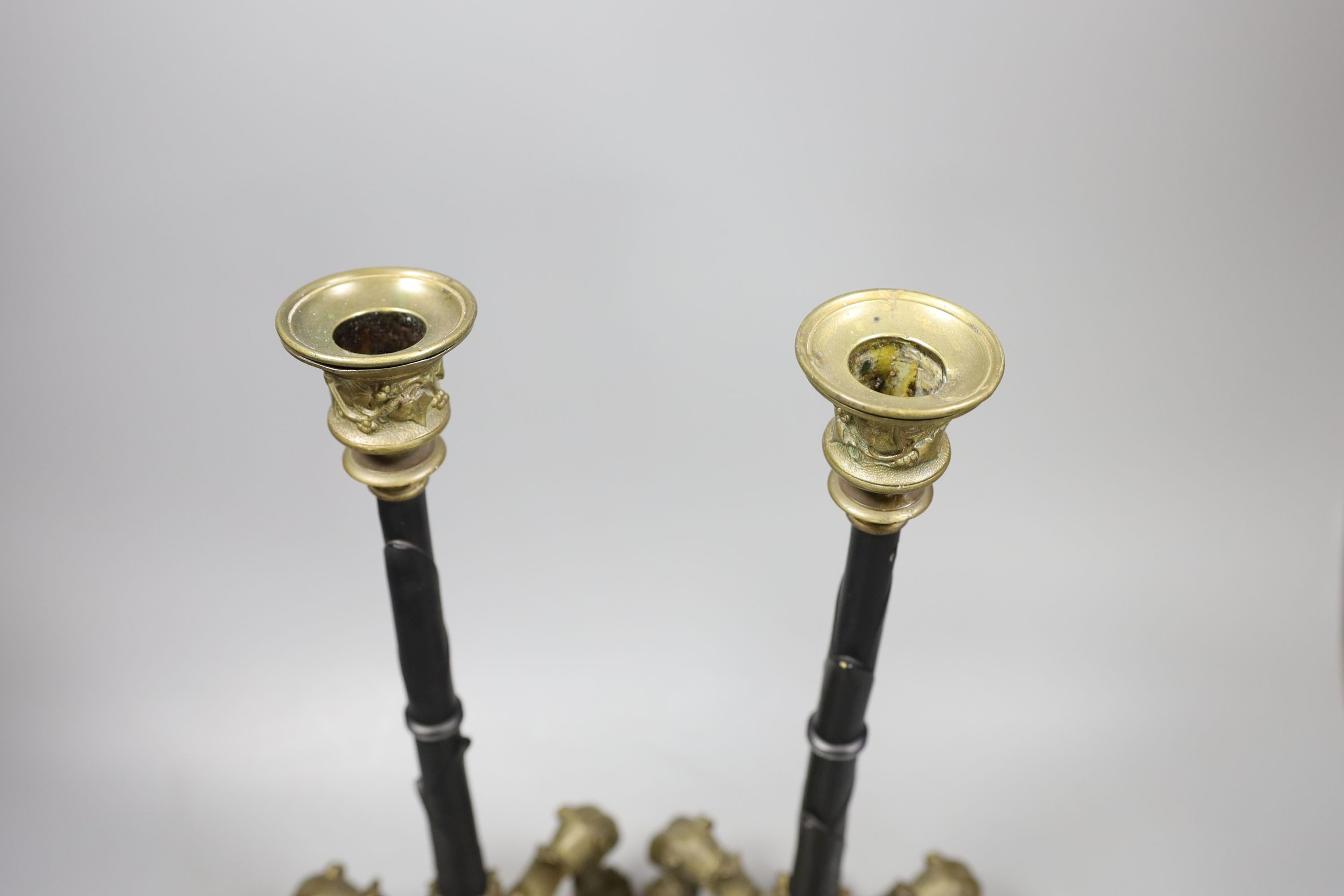 A pair of French ormolu puma footed candlesticks 33cm
